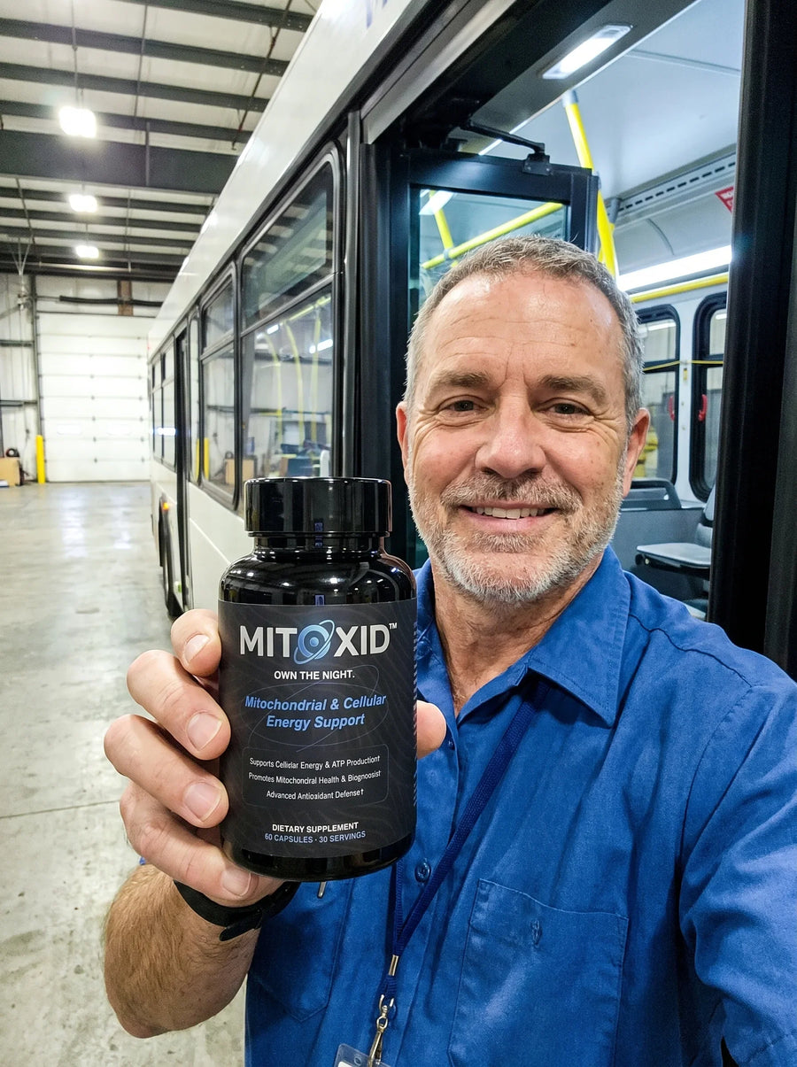 Customer photo: a bus driver at the depot door holding the Mitoxid bottle