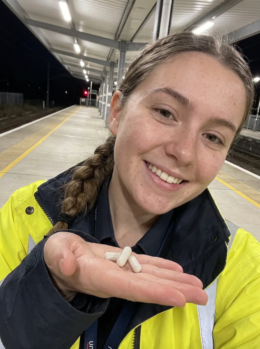 Customer photo: a station platform worker in hi vis with Mitoxid capsules in her palm